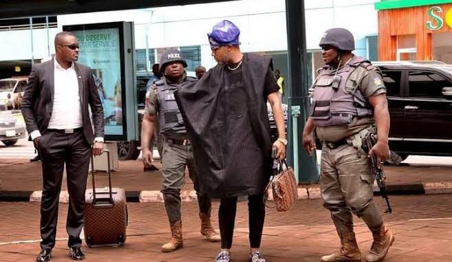 A Nigerian entertainer, E-money  and hos police orderlies (Green-White-Green)