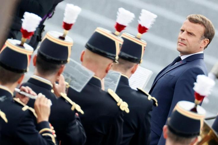 French President Emmanuel Macron reviews the guard of honour during the annual Bastille Day military ceremony in Paris