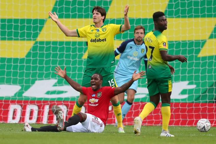 Manchester United forward Victor Ighalo is floored by a foul which resulted in Norwich City defender Timm Klose (L) beind red-carded