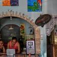 Ana Arias (R), 40, mother of Luisannys Betancourt, who disappeared in a shipwreck en route from Venezuela to Trinidad and Tobago on April 23, 2019, looks for pictures of her daughter in a computer  at her house in Cumana, Sucre State, Venezuela