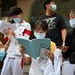 Students get in some last minute study outside a school before entering to sit the National College Entrance Examination (NCEE), known as Gaokao, in Beijing