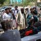 A  man injured in an explosion at a cattle market is brought to in Lashkar Gah, Helmand province