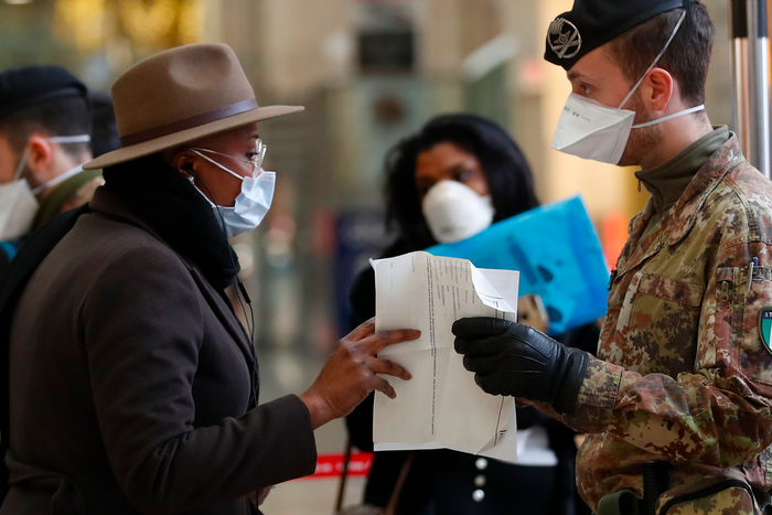 Police officers and soldiers check passengers leaving from Milan main train station, Italy, Monday, March 9, 2020. Italy took a page from China's playbook Sunday, attempting to lock down 16 million people  more than a quarter of its population  for nea...
