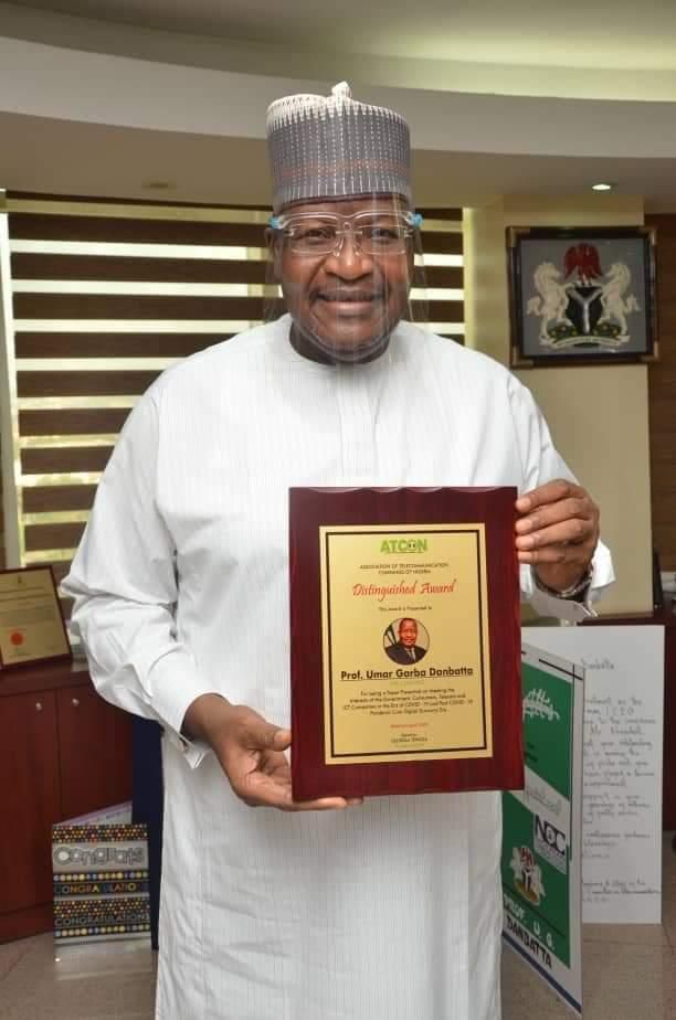Executive Vice Chairman/CEO, Nigerian Communications Commission (NCC),  Prof.  Umar Garba Danbatta displaying the award.