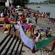 Indians dry their clothes after taking a holy dip in the River Ganges at Rishikesh, where about 700 foreign tourists remain as India's virus lockdown continues