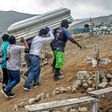 Relatives carry the coffin of a suspected COVID-19 victim in the outskirts of Lima, Peru
