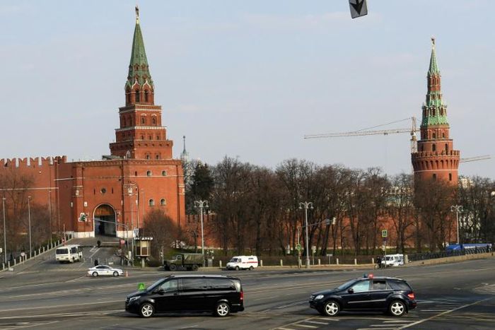 The patriarch's van with tinted windows was escorted by other vehicles with flashing emergency beacons