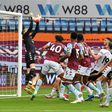 Aston Villa goalkeeper Orjan Nyland jumps to catch the ball before falling back into the goal