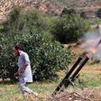 A fighter with Libya's UN-recognised Government of National Accord (GNA) fires rockets towards the city of Tarhuna, southwest of the capital Tripoli, held by the forces of the strongman Khalifa Haftar