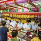 Customers in facemasks selling gold at a shop in Bangkok's Chinatown