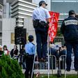 Police monitor a January 2019 protest in Hong Kong in support of jailed Chinese human rights lawyer Wang Quanzhang