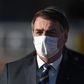 Brazilian President Jair Bolsonaro wears a face mask as he arrives at a flag-raising ceremony at the Alvorada Palace in Brasilia, Brazil, on May 12, 2020
