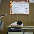 A jobseeker takes a break at a recruitment fair in Zhengzhou, China. Young graduates face a tough employment market