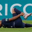 Kylian Mbappe clutches his right ankle after a foul by Loic Perrin in the French Cup final