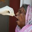 A woman is tested for coronavirus in New Delhi. Cases are soaring in the world's second most populous nation
