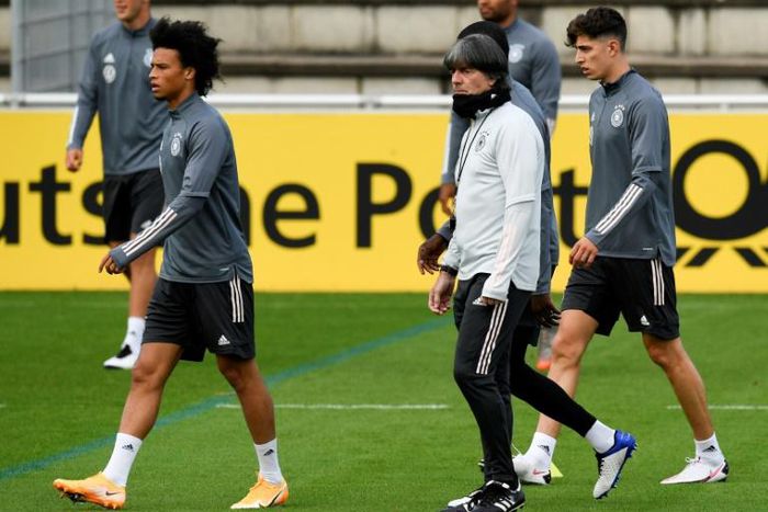 Germany head coach Joachim Loew (centre) oversees training in Stuttgart alongside Leroy Sane (left) and Kai Havertz (right).