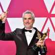 Alfonso Cuaron poses with his Oscars at the Academy Awards on February 24, 2019