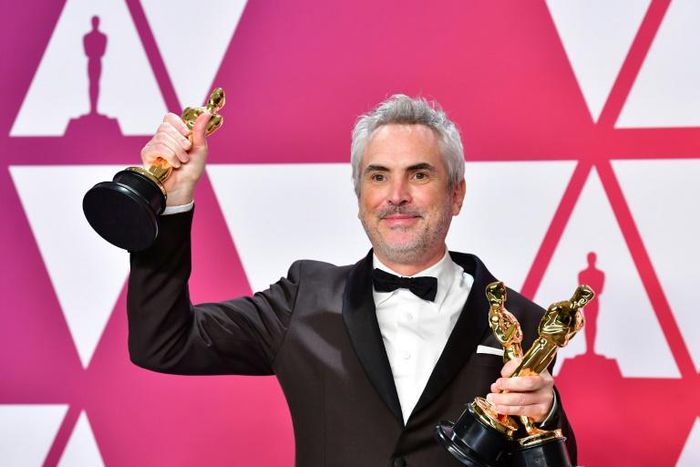 Alfonso Cuaron poses with his Oscars at the Academy Awards on February 24, 2019