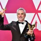 Alfonso Cuaron poses with his Oscars at the Academy Awards on February 24, 2019