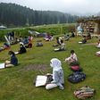 Students attend an open-air school in a highland meadow in in Doodhpathri, Indian-administered Kashmir
