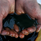 FILE PHOTO: An employee demonstrates a sample of crude oil in the Yarakta Oil Field, owned by Irkutsk Oil Company (INK), in Irkutsk Region, Russia in this picture illustration taken March 11, 2019. REUTERS/Vasily Fedosenko/Illustration/File Photo