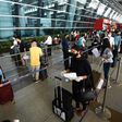 At New Delhi airport, hundreds of people anxious to get home but apprehensive about the risks queued from before dawn