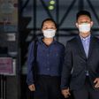 Elaine To, 41, and Henry Tong, 39, leave the District Court in Hong Kong after being found not guilty of rioting during last year's pro-democracy protests
