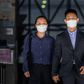 Elaine To, 41, and Henry Tong, 39, leave the District Court in Hong Kong after being found not guilty of rioting during last year's pro-democracy protests