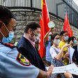 Pro-China activists holding placards and flags hand over a petition at the US consulate general in Hong Kong -- Washington has now imposed visa restrictions on Chinese officials over curbs on the city's autonomy