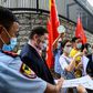 Pro-China activists holding placards and flags hand over a petition at the US consulate general in Hong Kong -- Washington has now imposed visa restrictions on Chinese officials over curbs on the city's autonomy