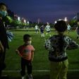 People play football in a field in Wuhan, in China's central Hubei province after coronavirus restrictions were eased