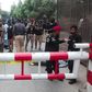 Policemen secure an area around a body outside the Pakistan Stock Exchange building after a group of gunmen attacked the building in Karachi