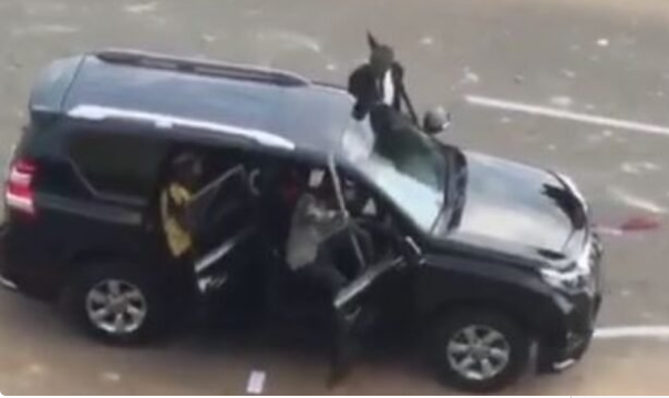 Hoodlums and some men in black suit driving towards protesters in Abuja (The Cable)