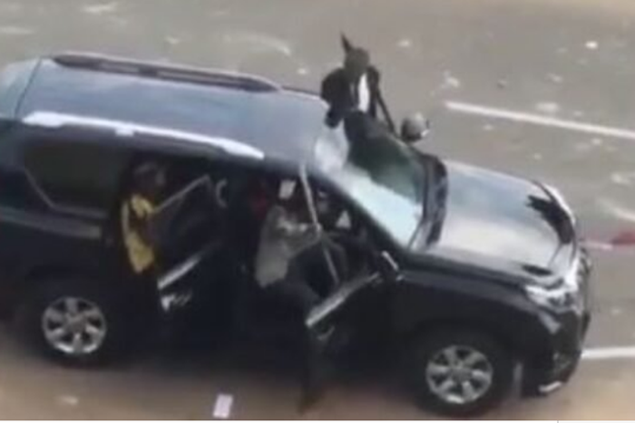 Hoodlums and some men in black suit driving towards protesters in Abuja (The Cable)