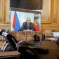 French President Emmanuel Macron talks to Russian President Vladimir Putin during a videoconference on June 26 at the Elysee Palace in Paris
