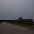 A woman rides her bike in front of El Morro Fort as a vast cloud of Sahara dust blankets the city of San Juan, Puerto Rico on June 22, 2020