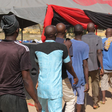 Men and boys released from Giwa Barracks after months or years of unlawful detention walk in a line as they are handed over to state officials in charge of a 'transit centre' where they will be held before returning to their communities, 27 November 20...