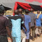 Men and boys released from Giwa Barracks after months or years of unlawful detention walk in a line as they are handed over to state officials in charge of a 'transit centre' where they will be held before returning to their communities, 27 November 20...