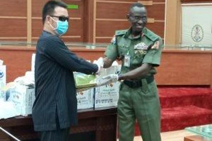 The Chief of Defence Training and Operations, Maj.-Gen. Lucky Irabor, receiving medical items donated to Defence Headquarters by the Mutual Commitment Company Ltd from its Managing Director, Mr Liu Zhao Lung in Abuja on Monday, 30/3/2020.