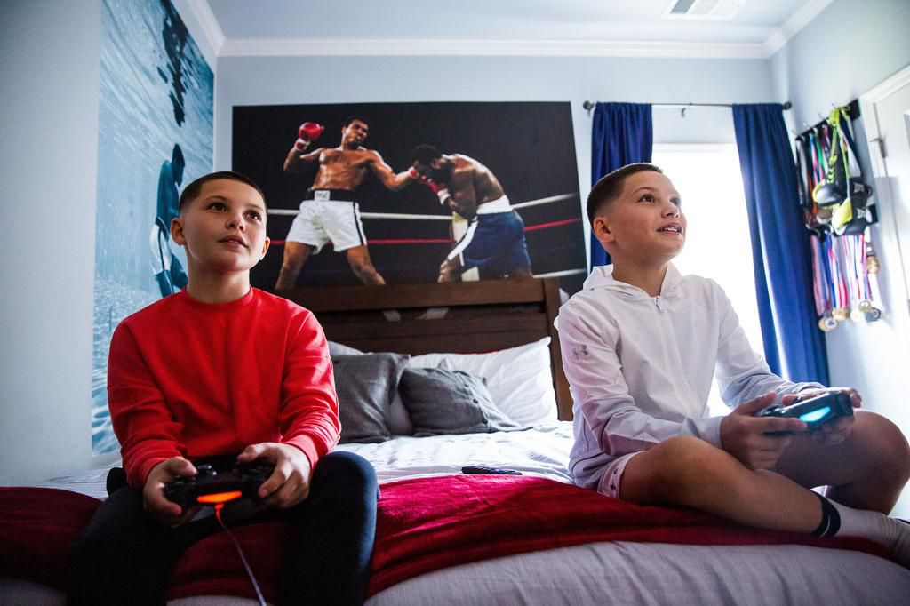 Walton (right) and  and his twin brother Jaden &quot;Jdub&quot; Walton play video games in Wannas room at thier home in Winder, Georgia.