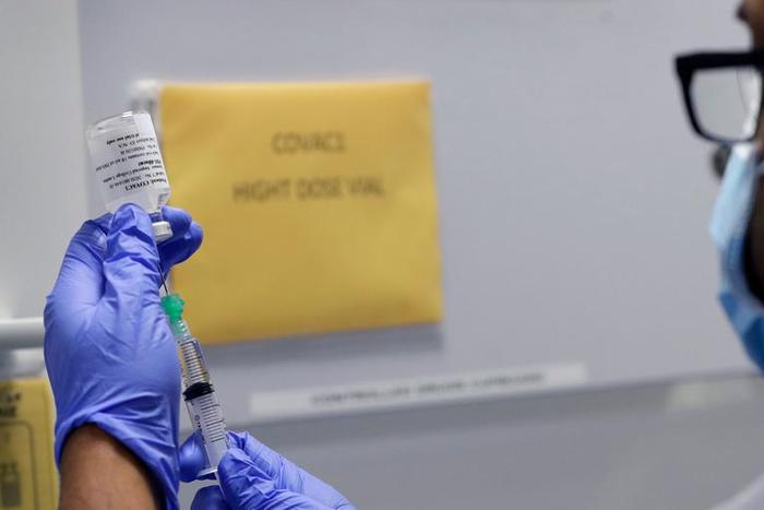 Senior Clinical Research Nurse Ajithkumar Sukumaran prepares the COVID 19 vaccine to administer to a volunteer, at a clinic in London, Wednesday, Aug. 5, 2020. Scientists at Imperial College London are immunizing hundreds of people with an experimental...