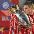 Liverpool's James Milner kisses the Premier League trophy