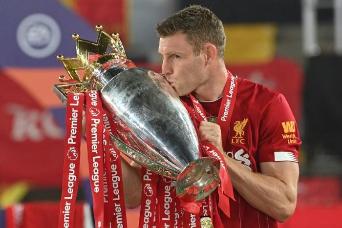 Liverpool's James Milner kisses the Premier League trophy