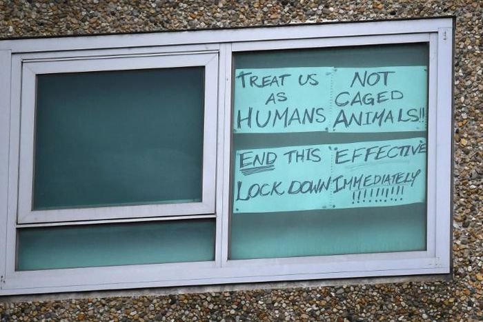 A sign is seen pasted on a window at one of nine public housing estates locked down due to a spike in COVID-19 coronavirus numbers in Melbourne