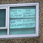 A sign is seen pasted on a window at one of nine public housing estates locked down due to a spike in COVID-19 coronavirus numbers in Melbourne