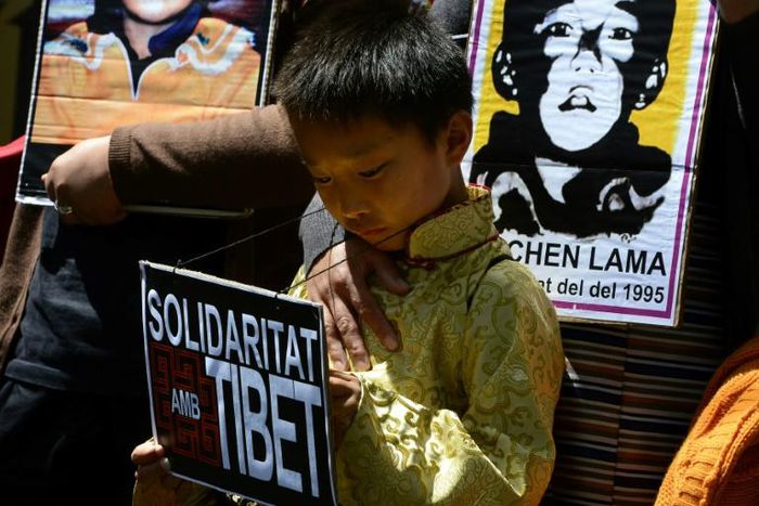 Protesters hold pictures of the missing Panchen Lama recognized by the Dalai Lama in a 2013 demonstration outside the Chinese consulate in Barcelona