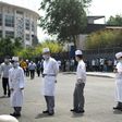 Restaurant workers line up in Beijing as part of a mass virus testing effort