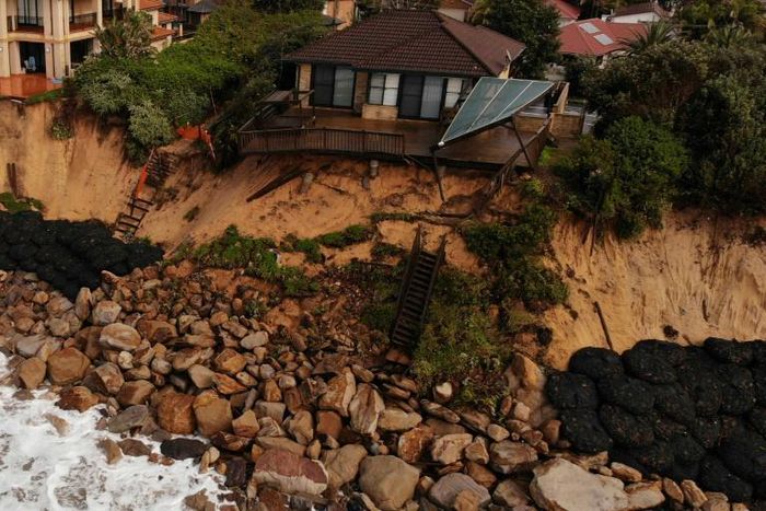 Dozens of seafront homes in Wamberal are at risk of falling into the sea after storms eroded the beach