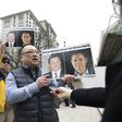 An activist in Vancouver on March 6, 2019 holds photos of Canadians Michael Spavor and Michael Kovrig, who are detained by China, outside British Columbia Supreme Court where Huawei executive Meng Wanzhou appeared
