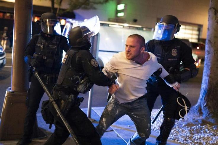 Police detain a man who was with the victim of a shooting in Portland, Oregon on August 29, 2020